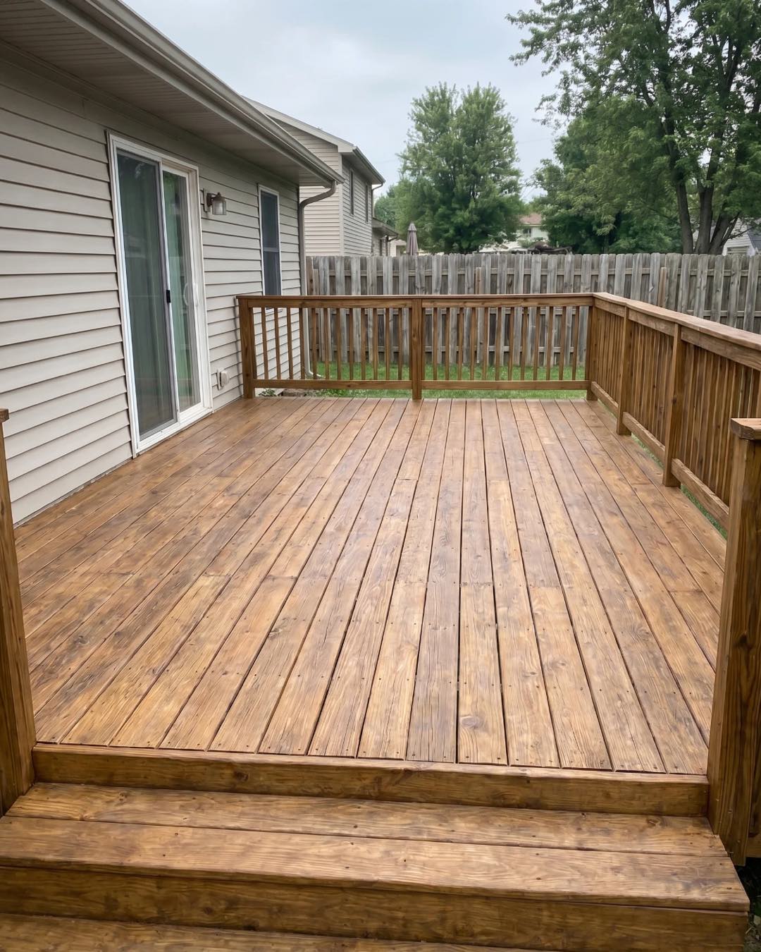 A Charlotte wood deck after cleaning, staining, and sealing