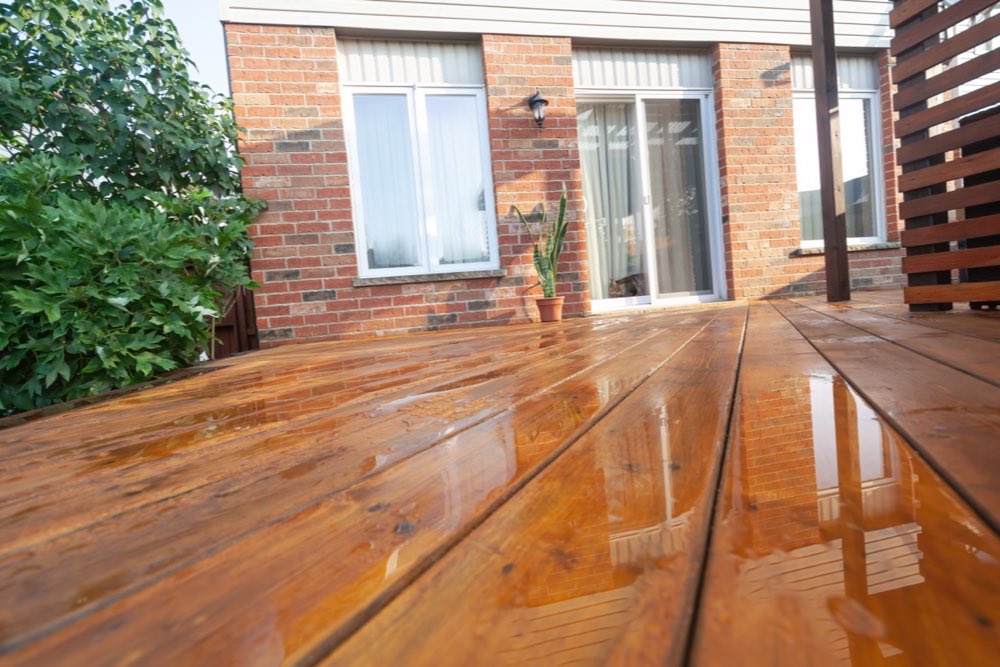 Water beading on a freshly sealed and stained wood deck in Charlotte