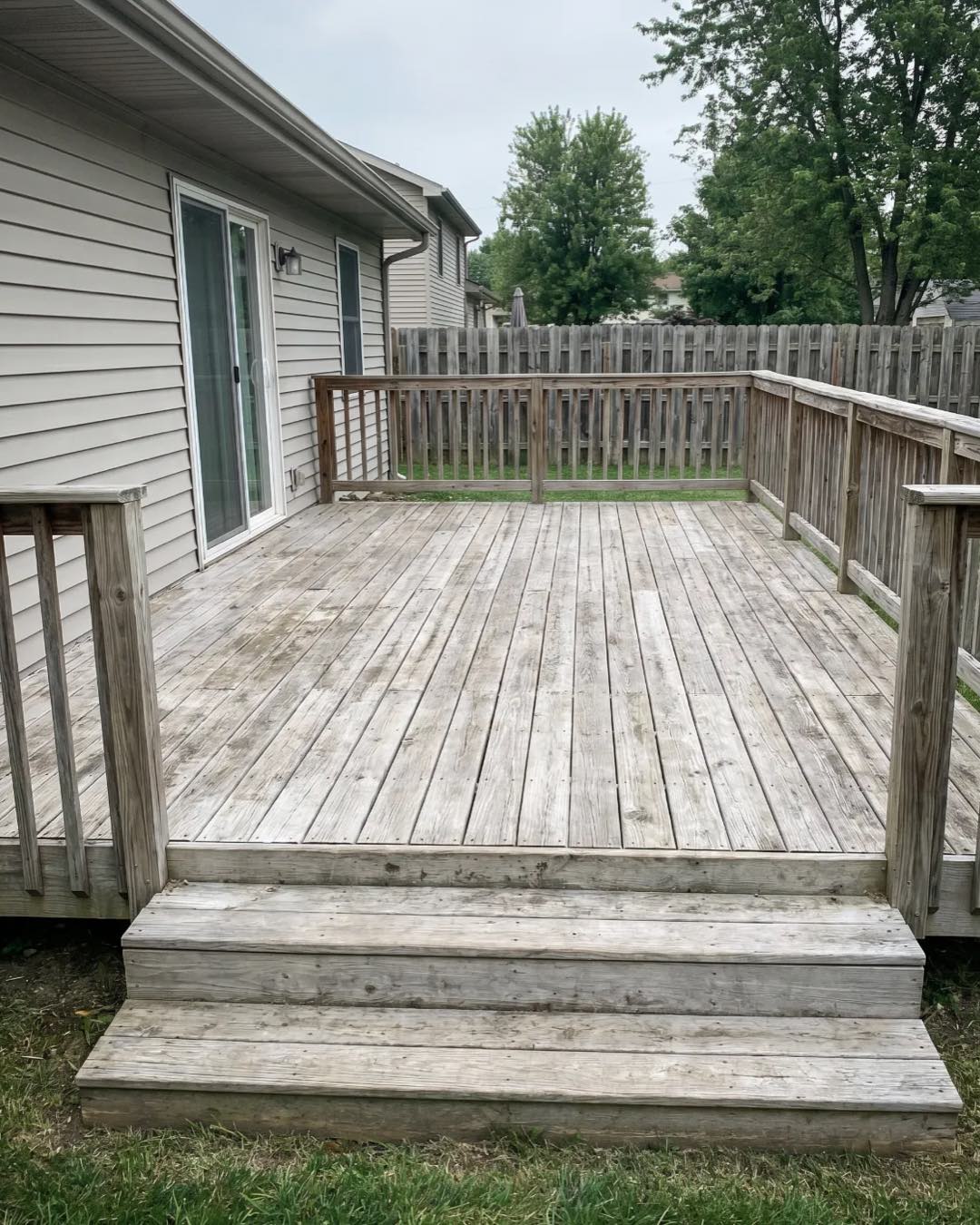 A weathered, gray wood deck in Charlotte before staining